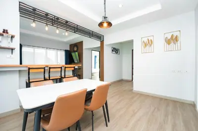 a dining room with a white table and chairs at The One Cozy, Phuket in Chalong