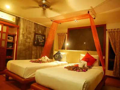 two beds in a hotel room with at Bangtao Beach Chalet Resort in Bang Tao Beach