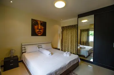 a bedroom with a large bed and a large mirror at Villa With Pool in Bang Tao Beach