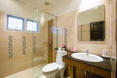 a bathroom with a toilet and a sink and a shower at Villa With Pool in Bang Tao Beach
