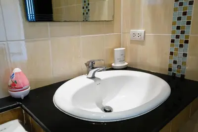 a white sink in a bathroom with a mirror at Villa With Pool in Bang Tao Beach