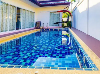 a swimming pool with blue tile in a house at Villa With Pool in Bang Tao Beach