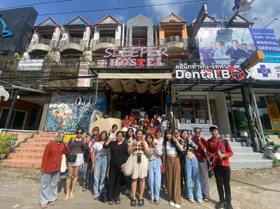 a group of people standing in front of a building at Sleeper Hostel in Ao Nang Beach