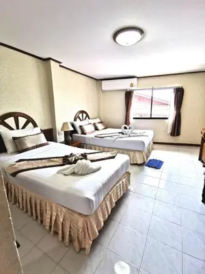 a hotel room with two beds in a room at Natacha Hotel in Phi Phi Don