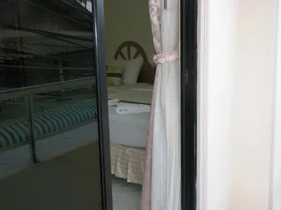 a reflection of a bedroom with a bed and a mirror at Natacha Hotel in Phi Phi Don