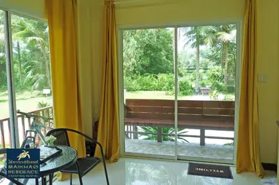 a room with a window with a view of a bench at MaiKhao Residence in Mai Khao Beach