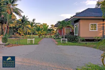 a house on a road in front of a house at MaiKhao Residence in Mai Khao Beach