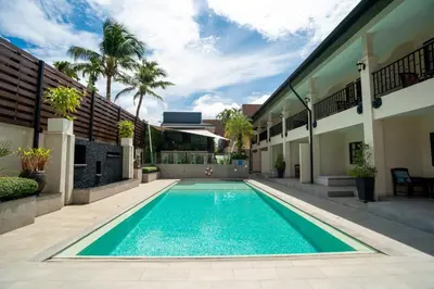 a swimming pool in the courtyard of a house at Naiya Buree Boutique Resort Nai Harn Beach in Rawai Beach
