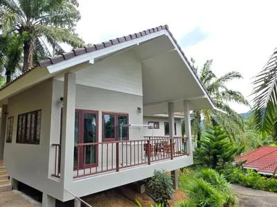 a small house with a balcony at Krabi Green Hill Pool Villas in Ban Nong Thale