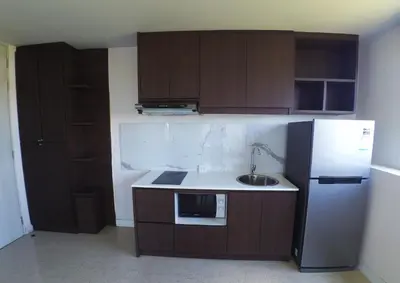 a small kitchen with a sink and a refrigerator at 1-BR Sea View, Aristo condo, Surin Beach in Surin Beach