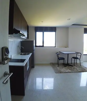 a kitchen with a table and a dining room at 1-BR Sea View, Aristo condo, Surin Beach in Surin Beach