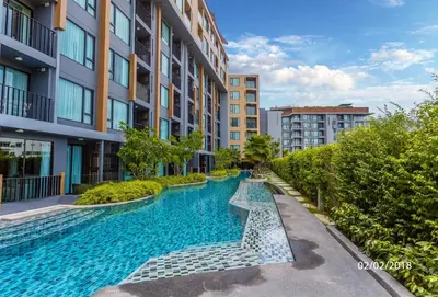 a swimming pool in the middle of a building at 1-BR Sea View, Aristo condo, Surin Beach in Surin Beach