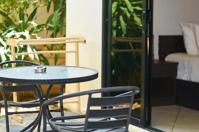a table and chairs sitting on a patio at Phuket Riviera Villas Hotel in Nai Harn Beach