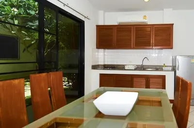 a kitchen with a table with a white bowl on it at Phuket Riviera Villas Hotel in Nai Harn Beach