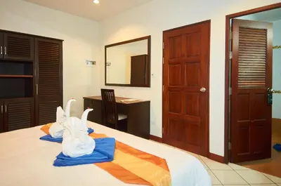 a bedroom with a bed with towels on it at Phuket Riviera Villas Hotel in Nai Harn Beach