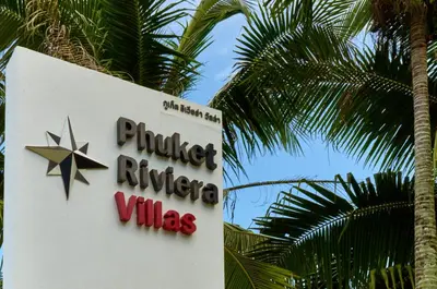 a sign for a producer nitrogenales sign next to a palm tree at Phuket Riviera Villas Hotel in Nai Harn Beach
