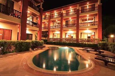 a hotel with a swimming pool in front of a building at Sun Hill Hotel Patong in Patong Beach