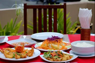a table with plates of food on a red table at Sun Hill Hotel Patong in Patong Beach