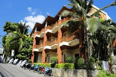 a building with motorcycles parked in front of it at Sun Hill Hotel Patong in Patong Beach