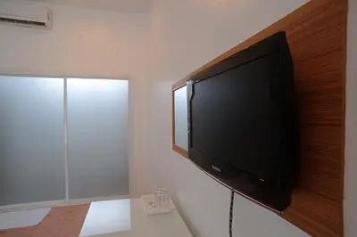 a flat screen tv hanging on a wall at Clear House Phuket in Kamala Beach
