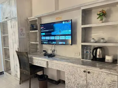 a counter with a television on top of it at The Shades Hotel 50 meter Beach Front in Patong Beach