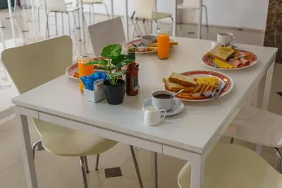 a table with two plates of breakfast food on it at The Shades Hotel 50 meter Beach Front in Patong Beach