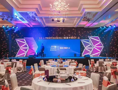 a set of tables in a room with a stage at Royal Phuket City Hotel in Phuket Town