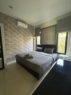 a bedroom with a large bed in a room at Baan Fran Sim Da in Bang Tao Beach