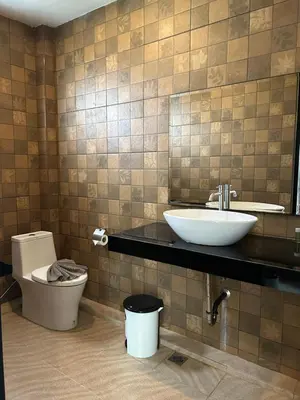 a bathroom with a sink and a toilet at Baan Fran Sim Da in Bang Tao Beach
