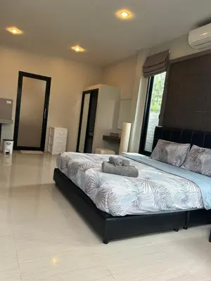 a bedroom with a bed with two towels on it at Baan Fran Sim Da in Bang Tao Beach