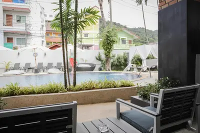 a view of the pool from the balcony of a hotel at ETK Patong Resort in Patong Beach