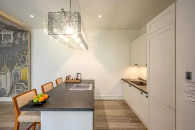 a kitchen with a table with a bowl of fruit on it at Maikhao Dream Villa Resort and Spa, Maikhao Phuket in Mai Khao Beach