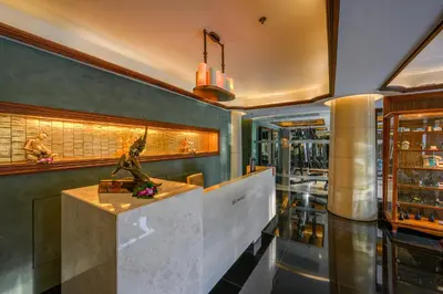a lobby of a restaurant with a statue on a counter at Maikhao Dream Villa Resort and Spa, Maikhao Phuket in Mai Khao Beach