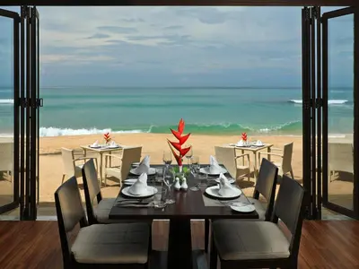 a dining table with a view of the beach at Natai Beach Resort in Natai Beach