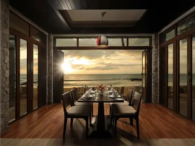 a dining room with a table and a view of the ocean at Natai Beach Resort in Natai Beach