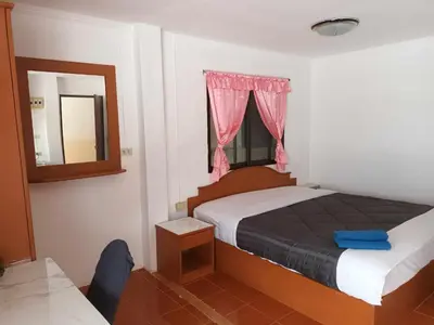 a small bedroom with a bed and a mirror at Patong Rose Guest House 50m to Beach in Patong Beach