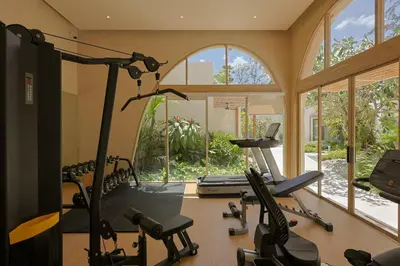 a gym with several treadmills and a treadmill at Eden Resort & Villas Phuket Patong in Patong Beach