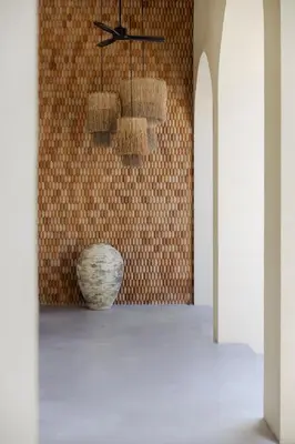 a room with a vase and a wall at Eden Resort & Villas Phuket Patong in Patong Beach