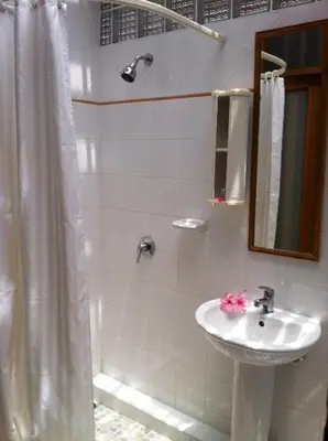 a white bathroom with a sink and a shower at Sea Pines & Liberg in Nai Yang Beach