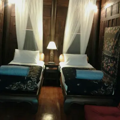 a bedroom with two beds and a lamp in it at Sea Pines & Liberg in Nai Yang Beach