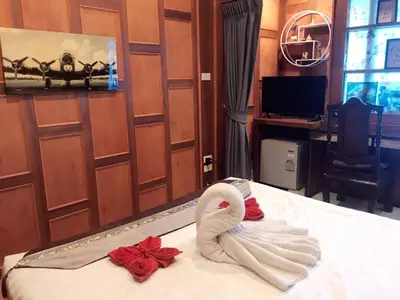 a swan made out of towels on a bed at Baan Ratchapruek in Phuket Town