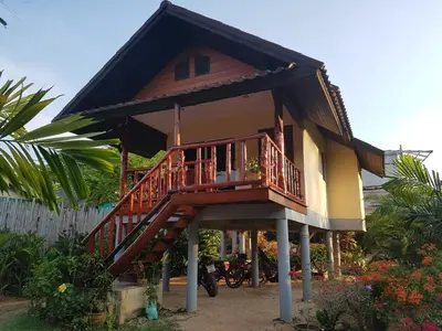 a small house with a staircase in front of it at Mookdaman Bungalow in Ko Yao Noi