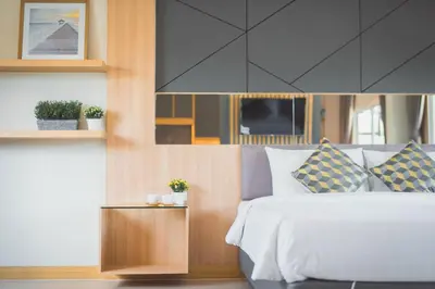a bedroom with a white bed and wooden walls at APA-TREE Boutique Hotel in Natai Beach