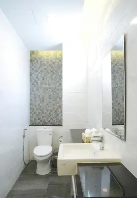 a white bathroom with a toilet and a sink at APA-TREE Boutique Hotel in Natai Beach