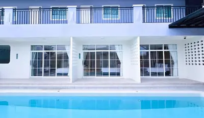 a house with a swimming pool next to a building at APA-TREE Boutique Hotel in Natai Beach
