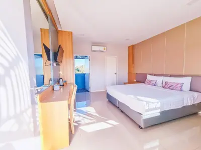 a bedroom with a bed and a desk in it at APA-TREE Boutique Hotel in Natai Beach