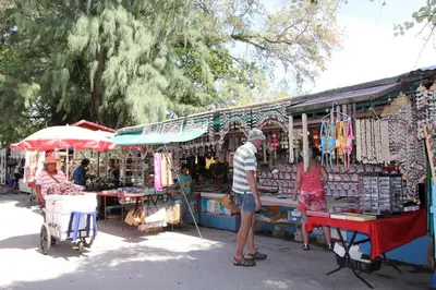 a man and a woman standing in front of a market at Rawai Palm Beach Resort - SHA Extra Plus in Rawai Beach