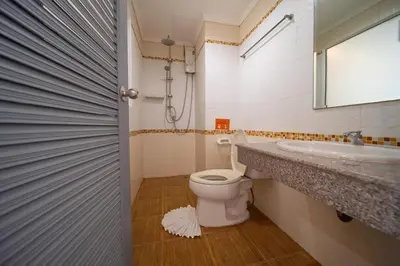 a bathroom with a toilet and a sink and a mirror at FunDee Boutique Hotel in Patong Beach