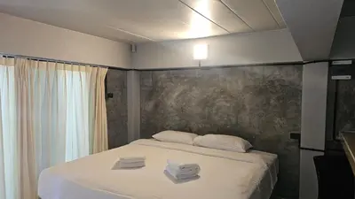 a bedroom with a bed with two towels on it at Classic home in Bang Tao Beach