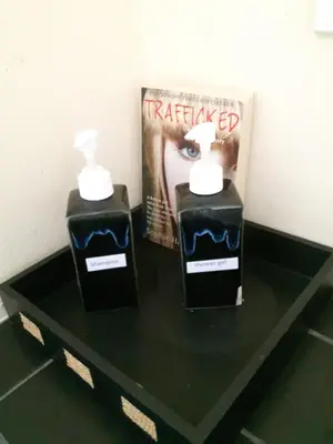 two bottles of hair products on a table with a magazine at Classic home in Bang Tao Beach